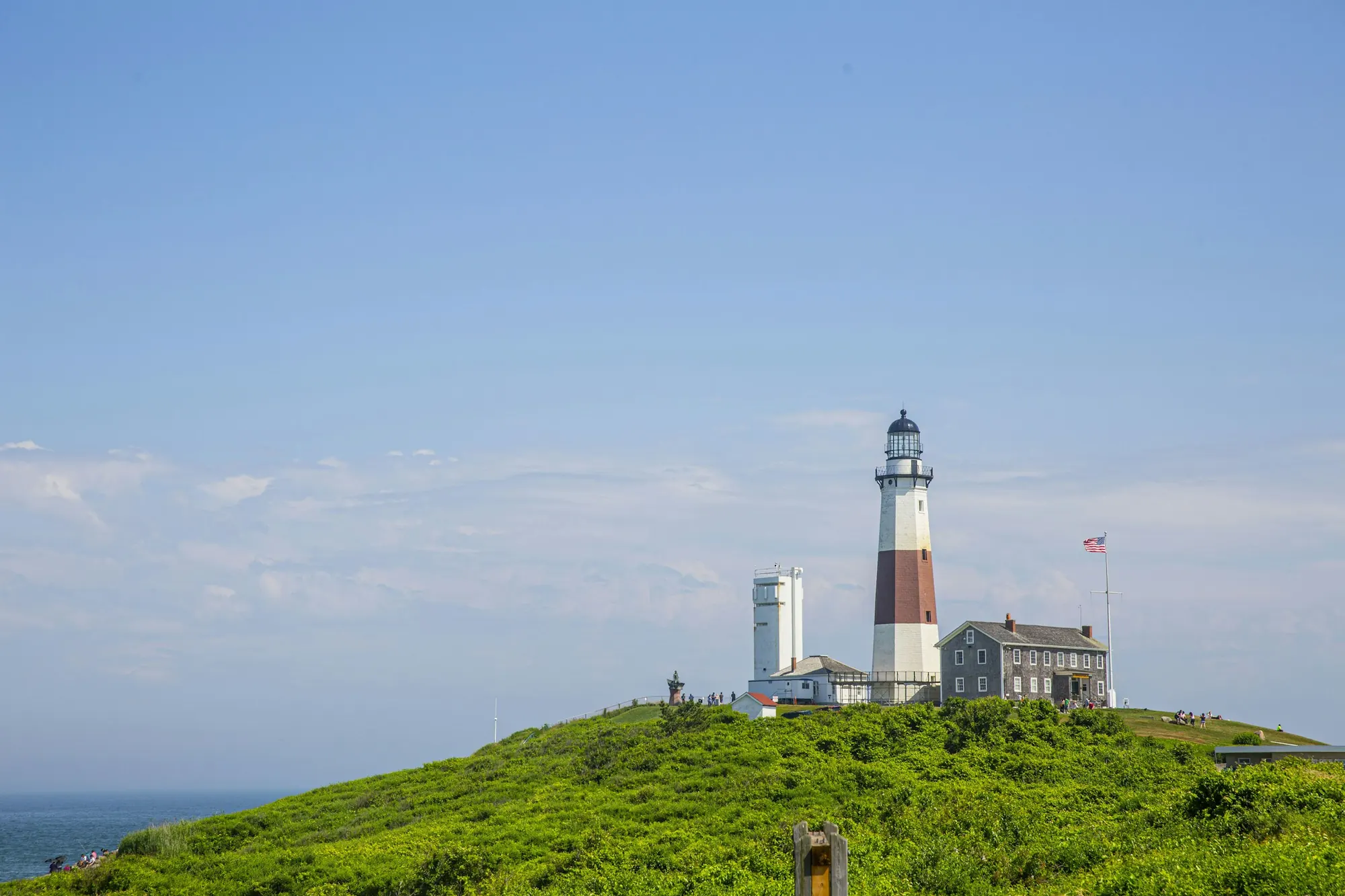 A lighthouse above the beach on the New England coast
