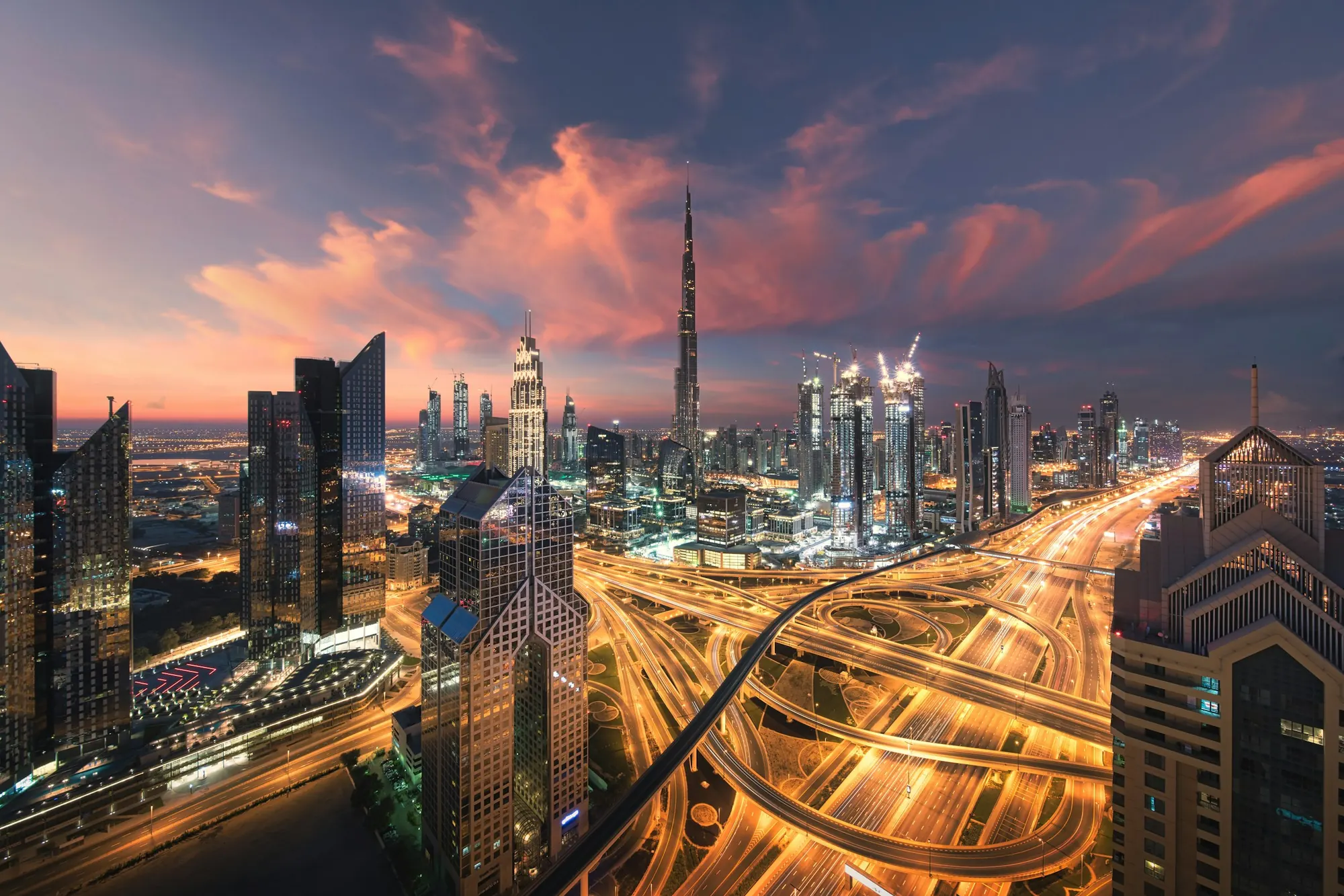 Long-exposure light trails on city highways at night