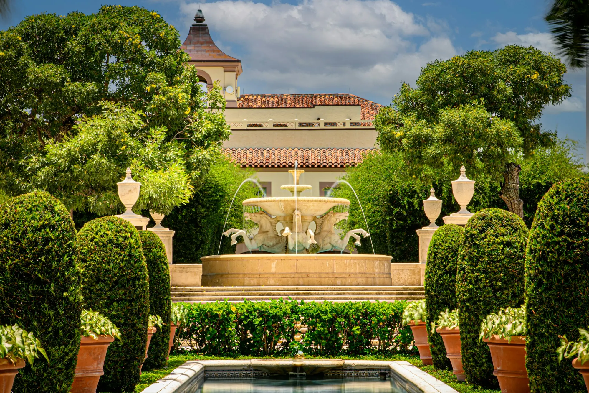 A fountain and palms in a Palm Beach garden courtyard